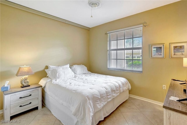 bedroom with light tile patterned floors