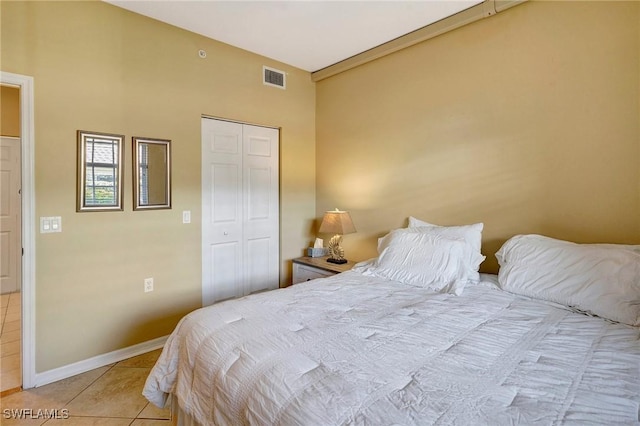 tiled bedroom with a closet