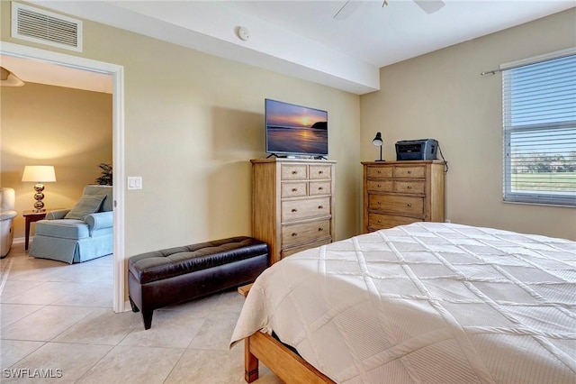 tiled bedroom with ceiling fan