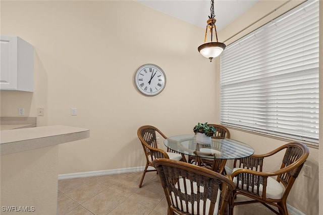 dining room featuring light tile patterned floors and baseboards