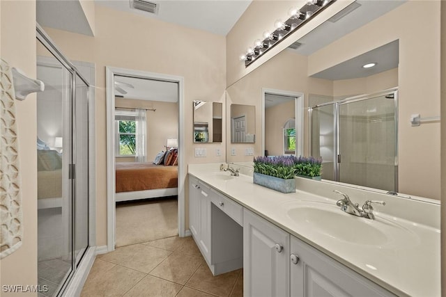 bathroom with a stall shower, visible vents, tile patterned floors, ensuite bathroom, and a sink