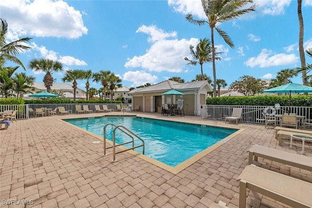 pool featuring fence and a patio