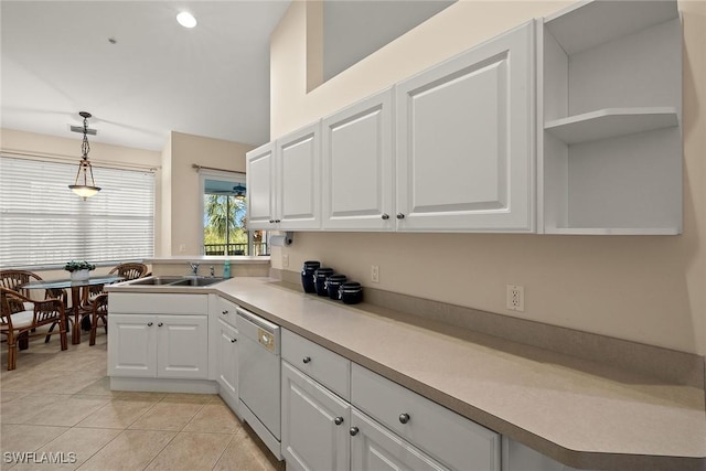 kitchen featuring a sink, white cabinets, light countertops, dishwasher, and pendant lighting