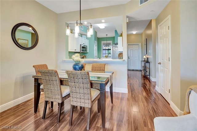 dining room with wood-type flooring