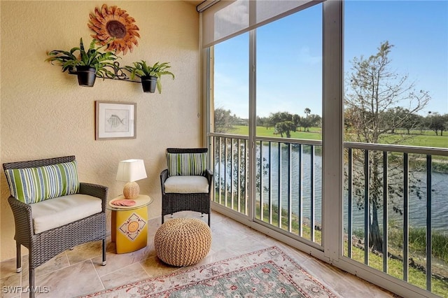 sunroom / solarium featuring a water view