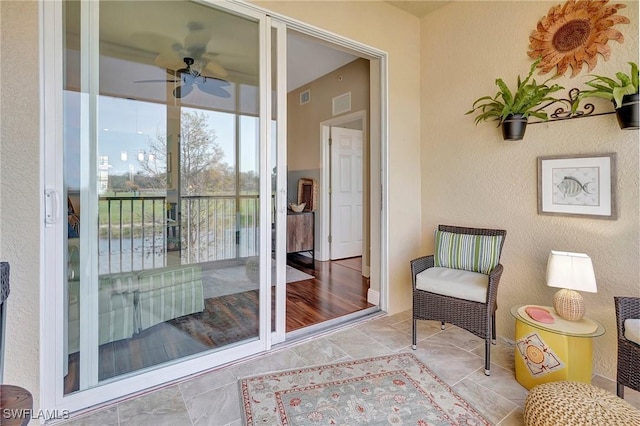 interior space with a patio and ceiling fan