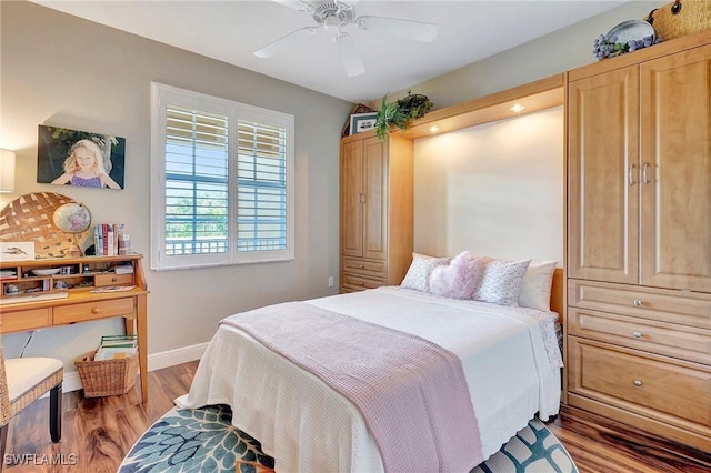 bedroom featuring ceiling fan, light wood finished floors, and baseboards