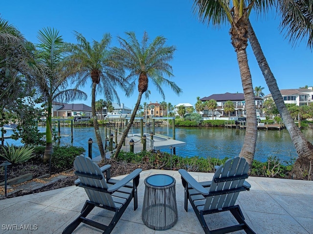 view of patio featuring a water view and a dock