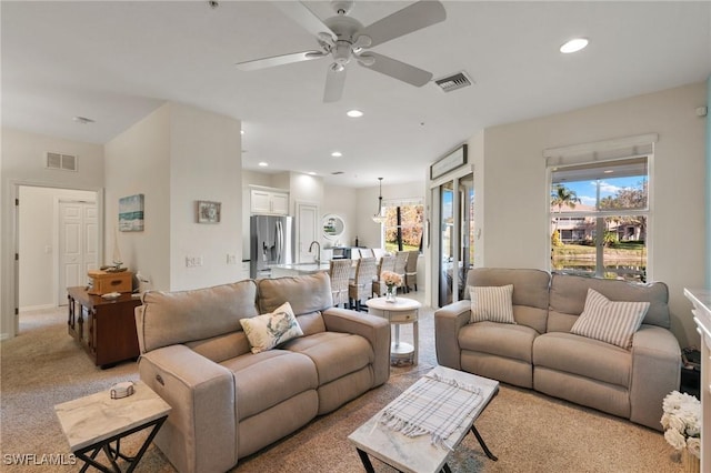 carpeted living room featuring ceiling fan