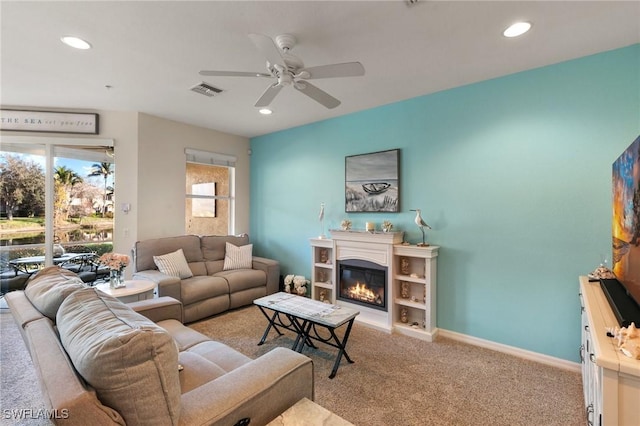 living room featuring light colored carpet and ceiling fan