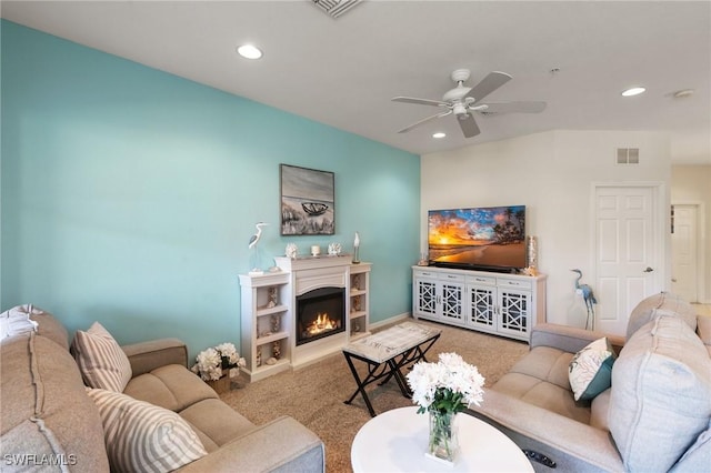 living room with ceiling fan and carpet