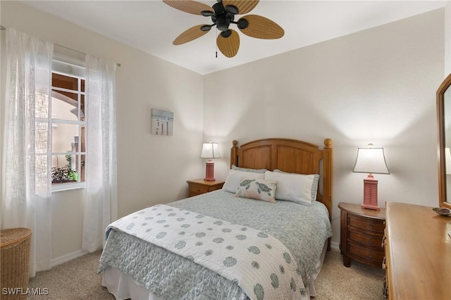 bedroom featuring light colored carpet and ceiling fan