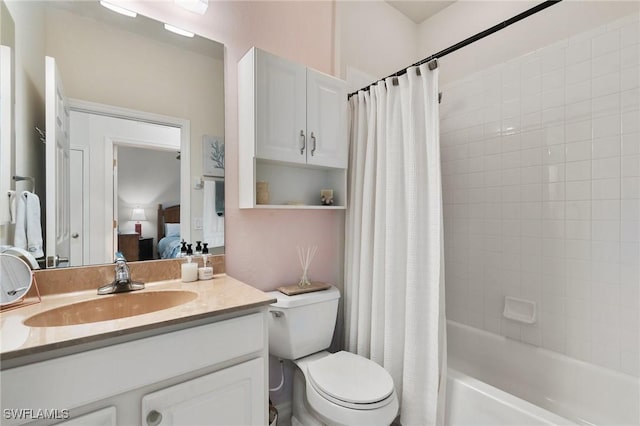 full bathroom with vanity, shower / tub combo, and toilet