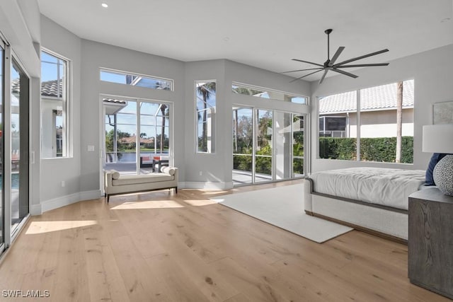 bedroom featuring access to exterior and light hardwood / wood-style flooring