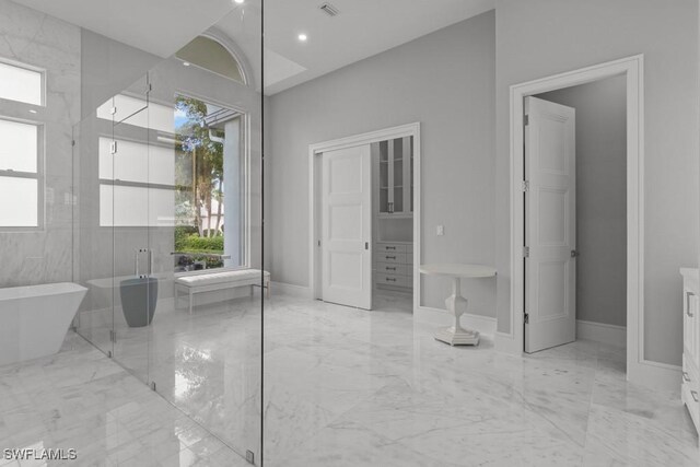 4306 Sanctuary Way, Bonita Springs, FL 34134 - full bathroom featuring marble finish floor, a wealth of natural light, and a soaking tub