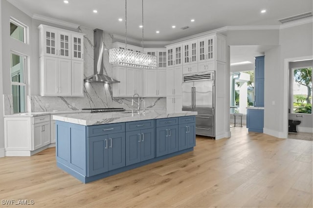 4306 Sanctuary Way, Bonita Springs, FL 34134 - kitchen featuring visible vents, appliances with stainless steel finishes, ornamental molding, white cabinetry, and wall chimney exhaust hood