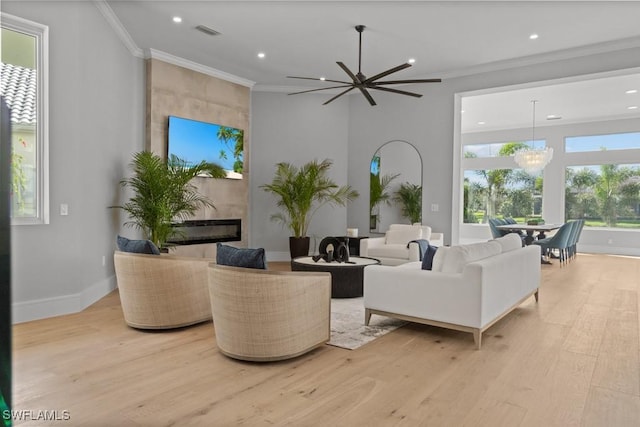 4306 Sanctuary Way, Bonita Springs, FL 34134 - living room featuring light wood-style floors, visible vents, a chandelier, and ornamental molding