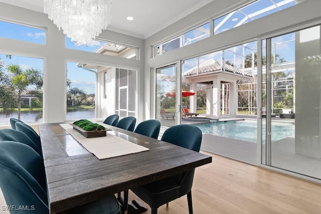 4306 Sanctuary Way, Bonita Springs, FL 34134 - sunroom featuring a water view, a wealth of natural light, and an inviting chandelier