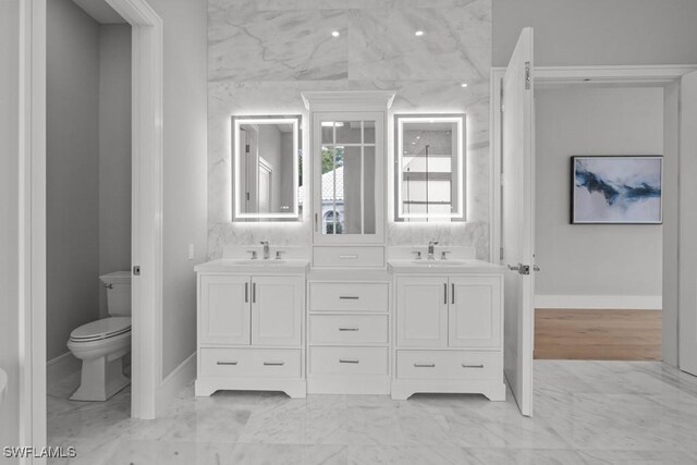 4306 Sanctuary Way, Bonita Springs, FL 34134 - bathroom featuring marble finish floor, a sink, toilet, and double vanity