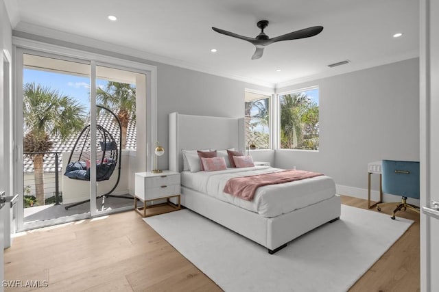 bedroom with crown molding, light hardwood / wood-style flooring, and ceiling fan