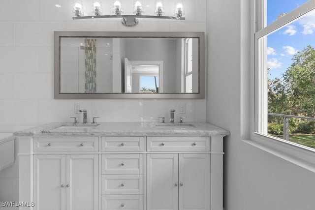 bathroom featuring plenty of natural light, vanity, and a shower