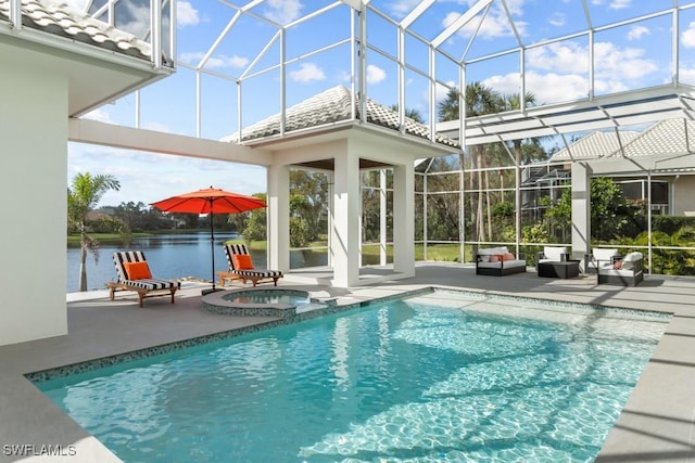 pool featuring an in ground hot tub, a patio area, a lanai, and a water view