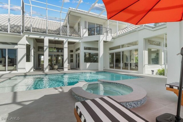 4306 Sanctuary Way, Bonita Springs, FL 34134 - view of swimming pool with glass enclosure, a pool with connected hot tub, and a patio