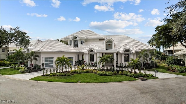 4306 Sanctuary Way, Bonita Springs, FL 34134 - mediterranean / spanish-style house with a garage, stucco siding, a tile roof, decorative driveway, and a front yard