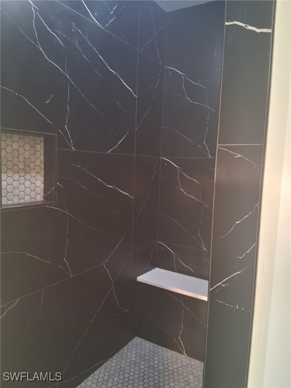 bathroom with a tile shower