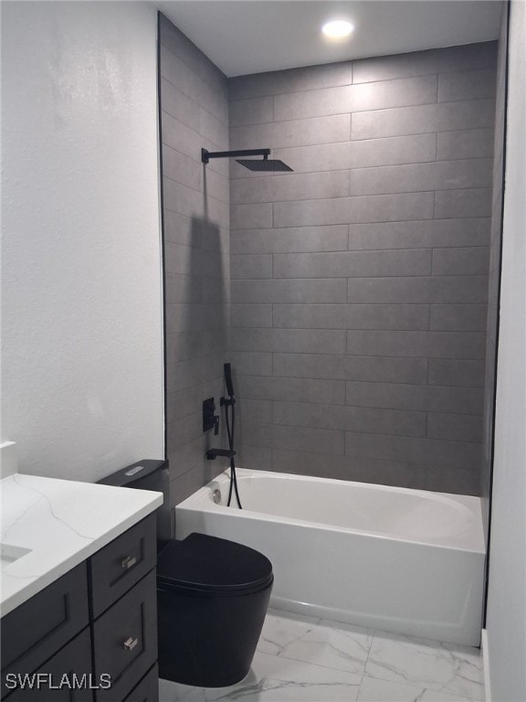 full bathroom featuring vanity, toilet, and tiled shower / bath