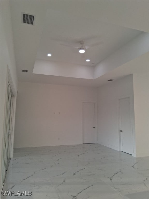 unfurnished room with a tray ceiling