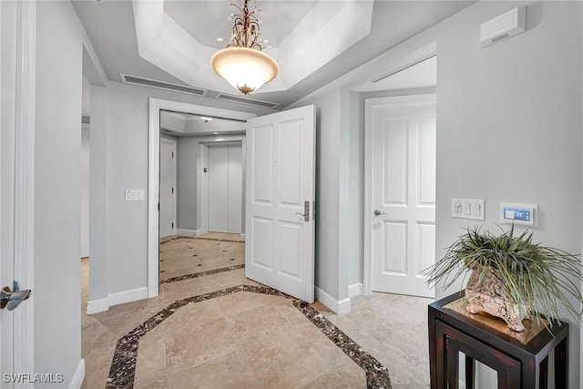 hall with a raised ceiling