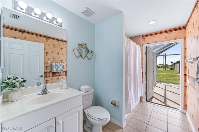 bathroom with tile patterned flooring, vanity, and toilet