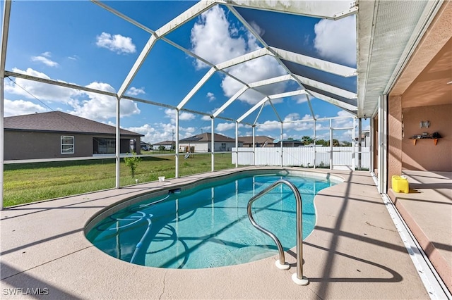 view of swimming pool featuring a yard, a patio, and glass enclosure