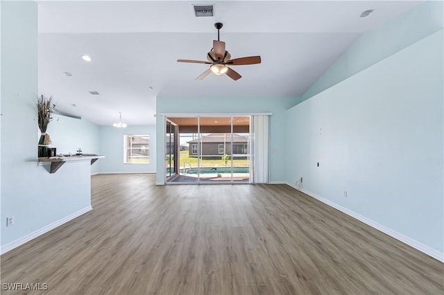 unfurnished living room featuring lofted ceiling, wood-type flooring, and ceiling fan