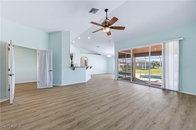 unfurnished living room featuring ceiling fan, wood-type flooring, and high vaulted ceiling