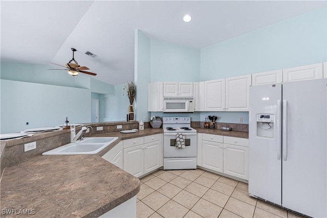 kitchen with light tile patterned floors, sink, white appliances, white cabinets, and kitchen peninsula