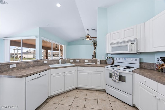 kitchen with sink, white appliances, ceiling fan, white cabinets, and vaulted ceiling