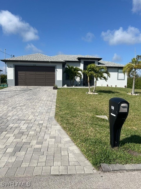 view of front facade featuring a garage and a front lawn