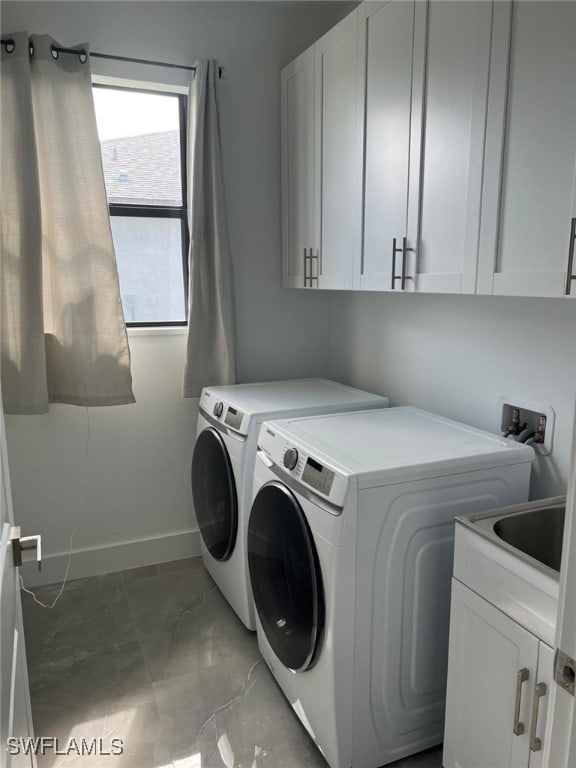 washroom with washing machine and dryer and cabinets