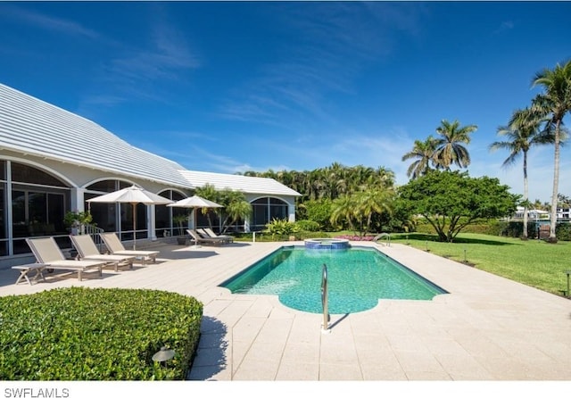 view of swimming pool with a yard, a pool with connected hot tub, and a patio