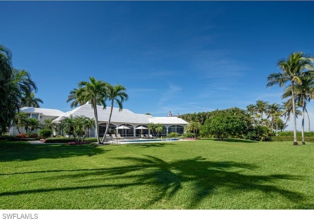 view of yard with a lanai and an outdoor pool