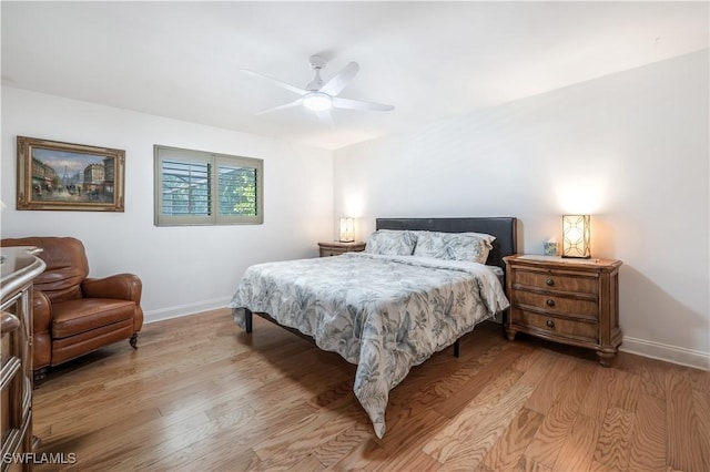 bedroom featuring ceiling fan, light wood finished floors, and baseboards