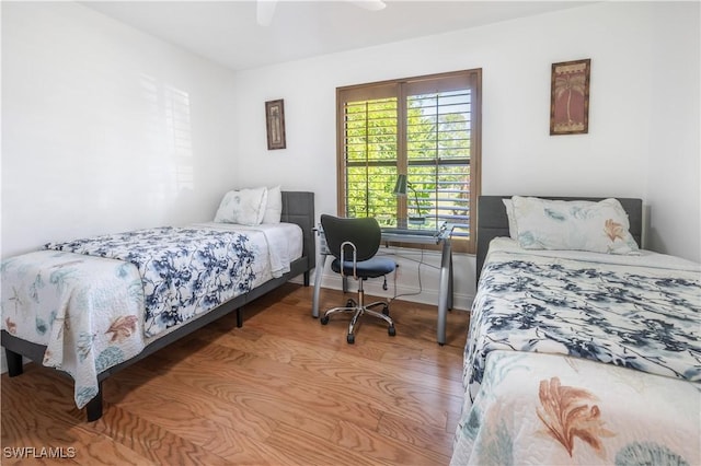 bedroom with light wood finished floors and a ceiling fan