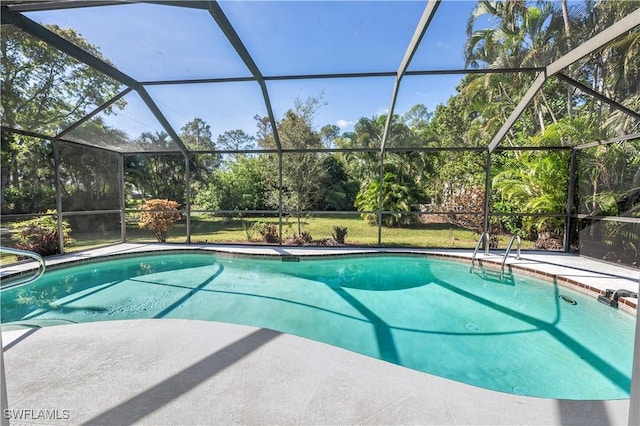 outdoor pool featuring glass enclosure and a patio area