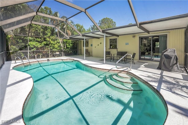 outdoor pool featuring glass enclosure and a patio