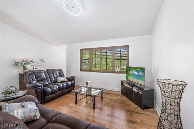 living room featuring light wood-type flooring and baseboards