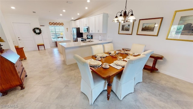 6082 National Blvd Unit 128, Ave Maria, FL 34142 - dining space featuring light tile patterned flooring, a chandelier, and vaulted ceiling