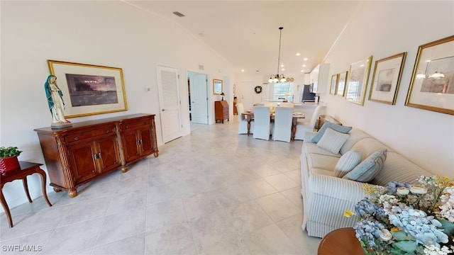 6082 National Blvd Unit 128, Ave Maria, FL 34142 - living room with a chandelier, high vaulted ceiling, and light tile patterned floors