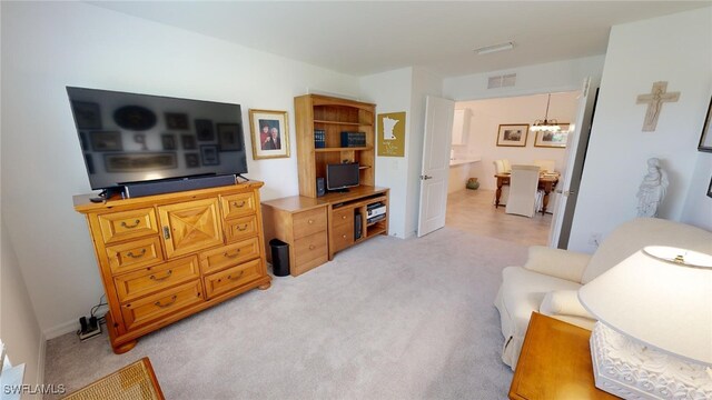 6082 National Blvd Unit 128, Ave Maria, FL 34142 - living room with light colored carpet and a chandelier